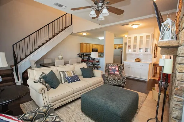 a living room with furniture and a chandelier