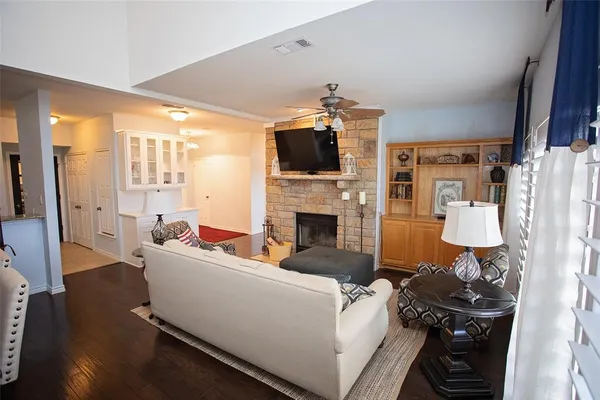 a living room with furniture a flat screen tv and a fireplace