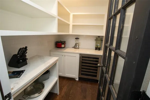 a kitchen with white cabinets and appliances
