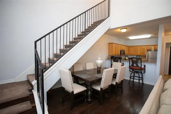 a view of dining room and livingroom with furniture wooden floor and windows