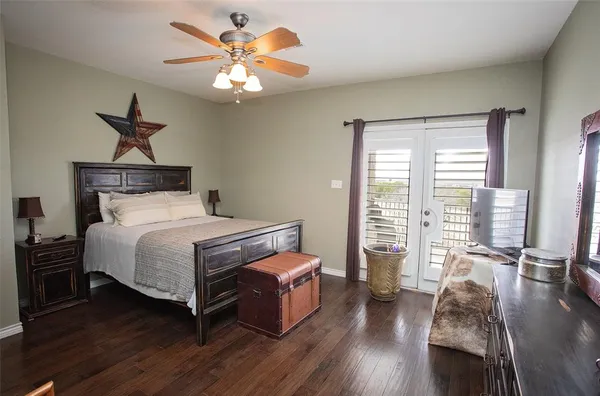 a bedroom with a bed a chandelier and a large window