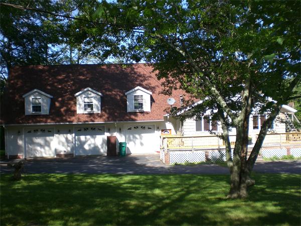 a view of house with yard in front of it