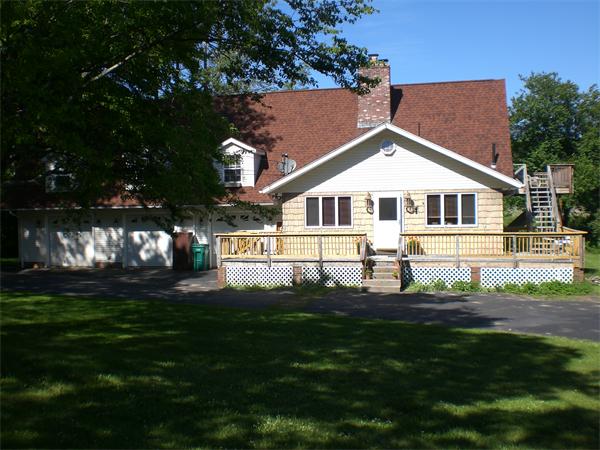 698 Town Farm Road Warren, MA 01083 - Photo 3 of 19 a front view of a house with a garden and yard