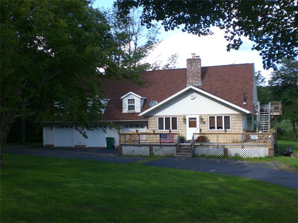 698 Town Farm Road Warren, MA 01083 - Photo 5 of 19 a front view of a house with a garden and trees