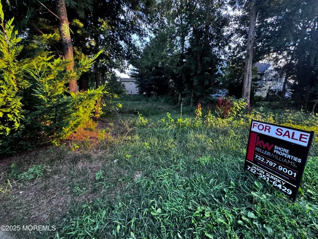 a view of a street with wooden fence