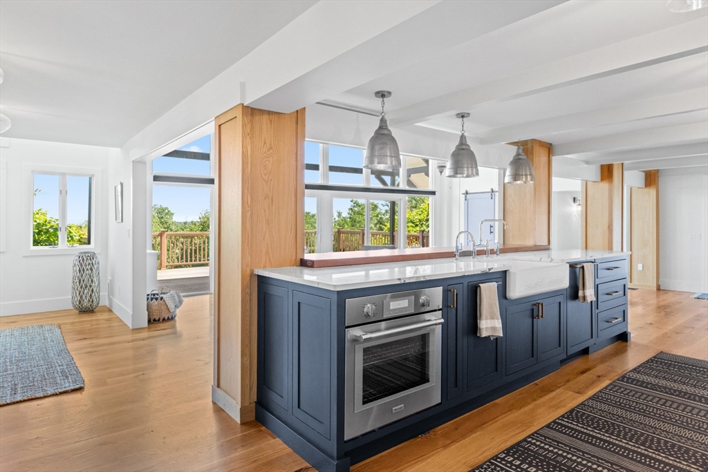 56 Hill Top Road Gloucester, MA 01930 - Photo 15 of 35 a kitchen with stainless steel appliances granite countertop a stove and a wooden floors
