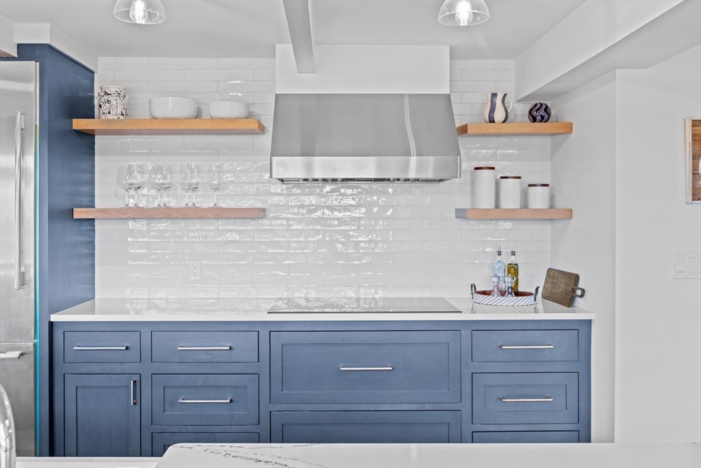 56 Hill Top Road Gloucester, MA 01930 - Photo 17 of 35 a kitchen with granite countertop cabinets and wooden floor