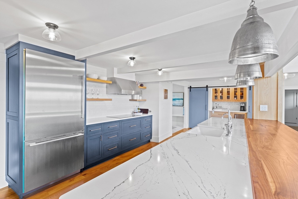 56 Hill Top Road Gloucester, MA 01930 - Photo 18 of 35 a large kitchen with stainless steel appliances kitchen island granite countertop a refrigerator and a sink