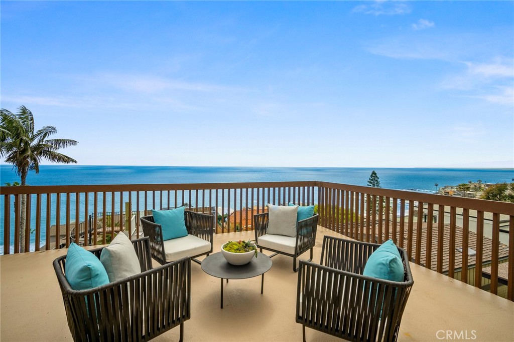 a patio with wooden floor barbeque oven and outdoor seating
