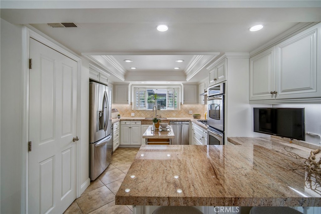 32041 Point Place Laguna Beach, CA 92651 - Photo 14 of 59 a kitchen with stainless steel appliances kitchen island granite countertop a refrigerator and a stove