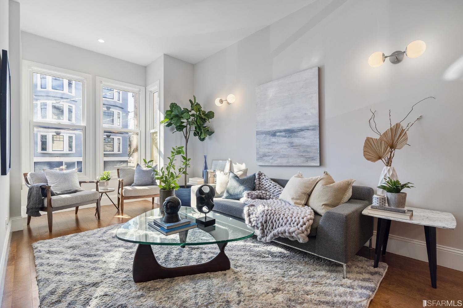 a living room with furniture potted plant and a table