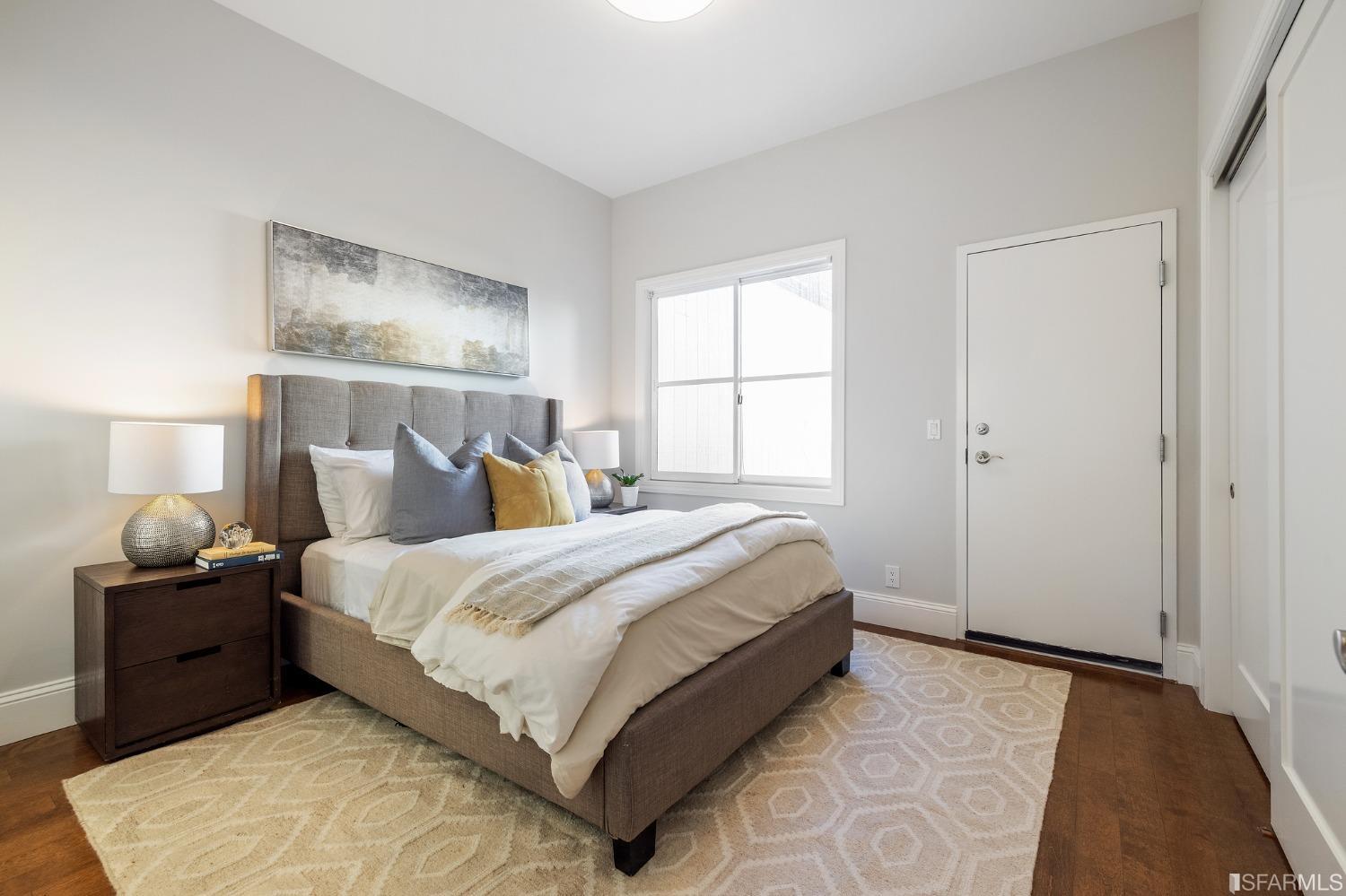 558 Central Avenue San Francisco, CA 94117 - Photo 11 of 23 a bedroom with a bed and wooden floor