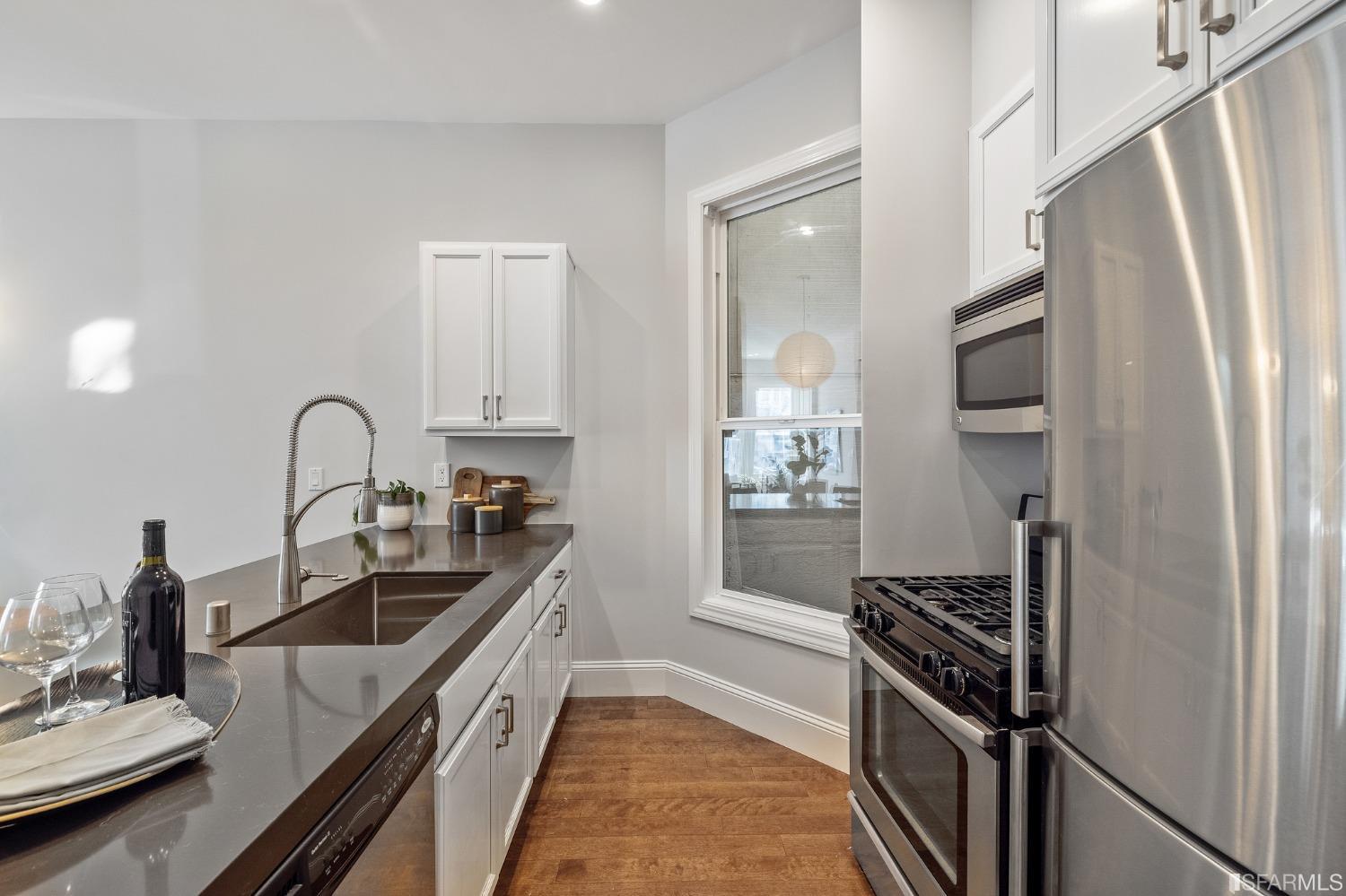 558 Central Avenue San Francisco, CA 94117 - Photo 8 of 23 a kitchen with stainless steel appliances granite countertop a sink stove and refrigerator