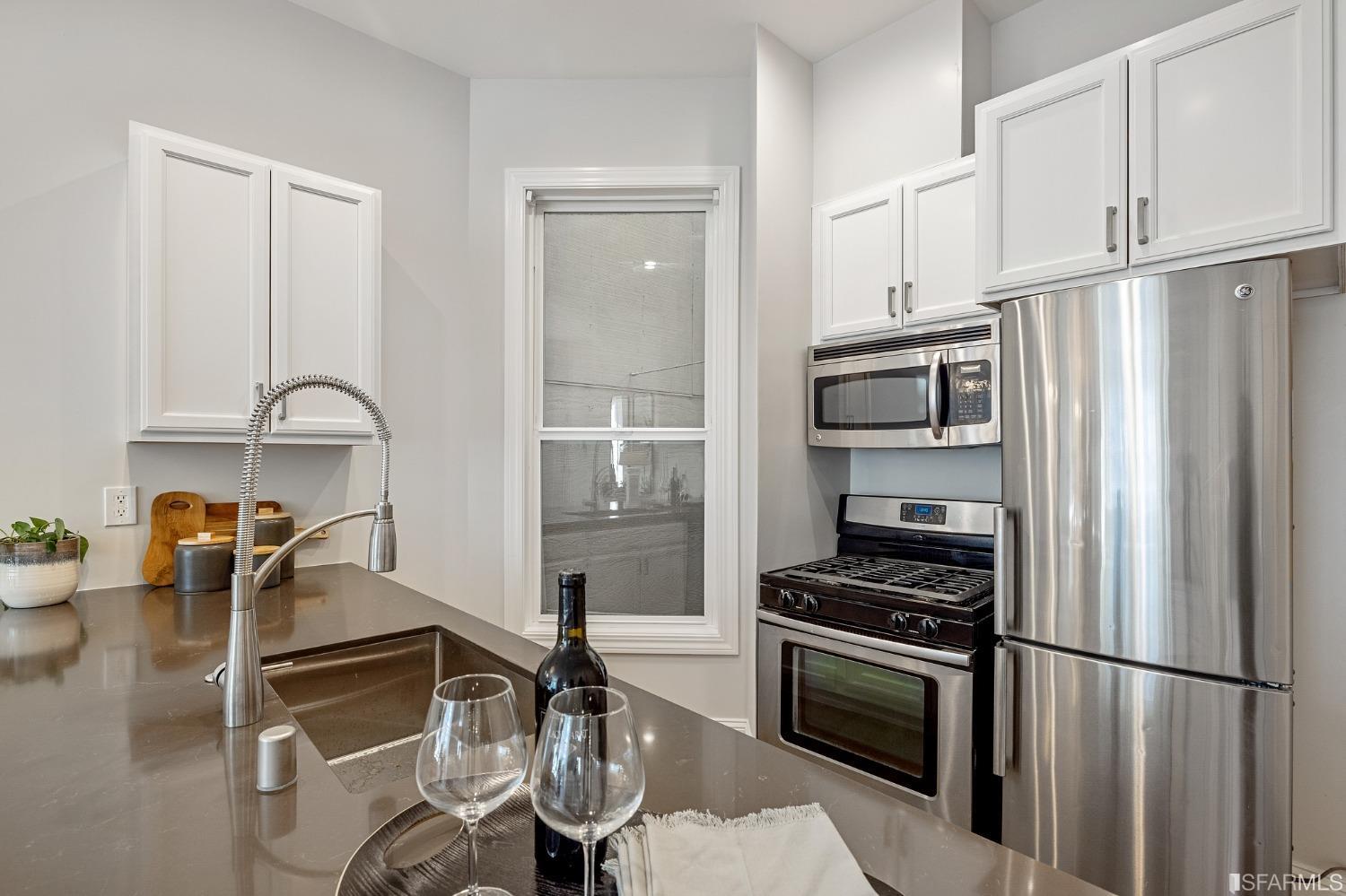 558 Central Avenue San Francisco, CA 94117 - Photo 9 of 23 a kitchen with granite countertop a refrigerator stove and sink
