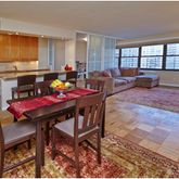 a living room with furniture a flat screen tv and a dining table
