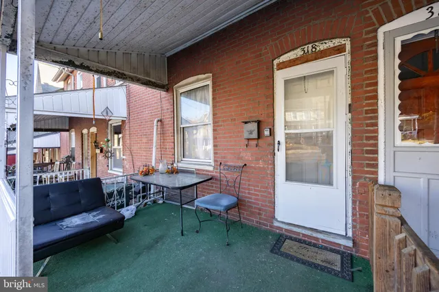 a balcony with furniture and a potted plant