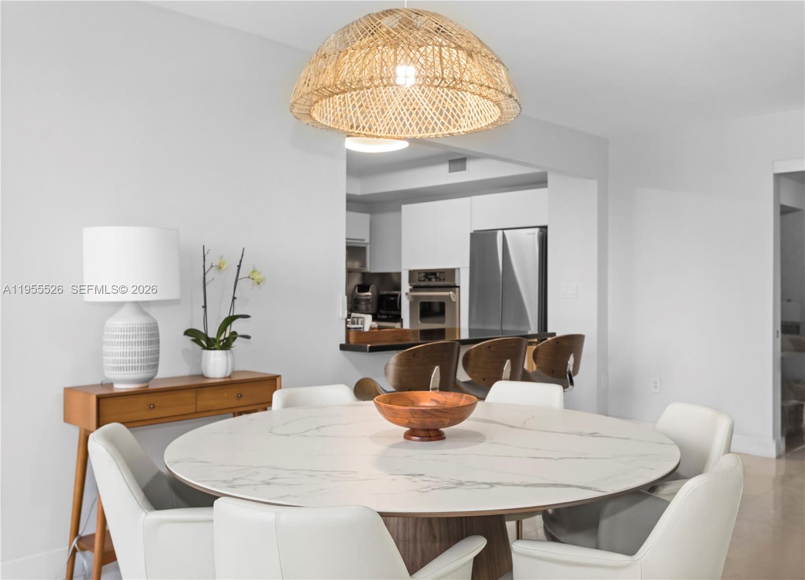 765 Crandon Boulevard, Unit 506 Key Biscayne, FL 33149 - Photo 13 of 19 a dining room with table and chairs