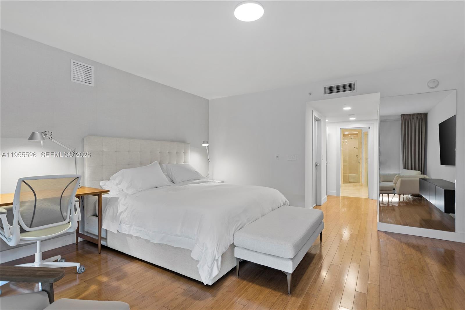 765 Crandon Boulevard, Unit 506 Key Biscayne, FL 33149 - Photo 3 of 19 a bedroom with a bed a chair and glass door