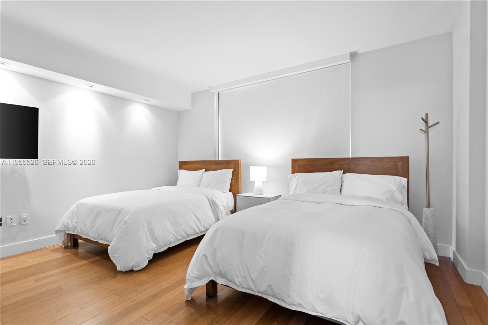 765 Crandon Boulevard, Unit 506 Key Biscayne, FL 33149 - Photo 8 of 19 a bedroom with two beds and a night stand