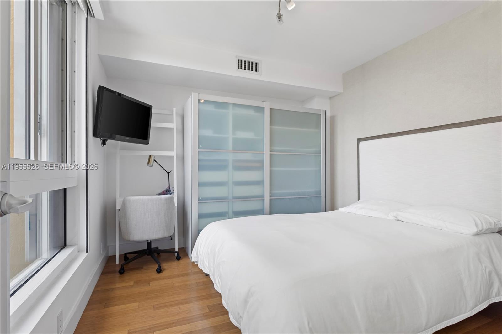 765 Crandon Boulevard, Unit 506 Key Biscayne, FL 33149 - Photo 10 of 19 a bedroom with a bed and a flat screen tv