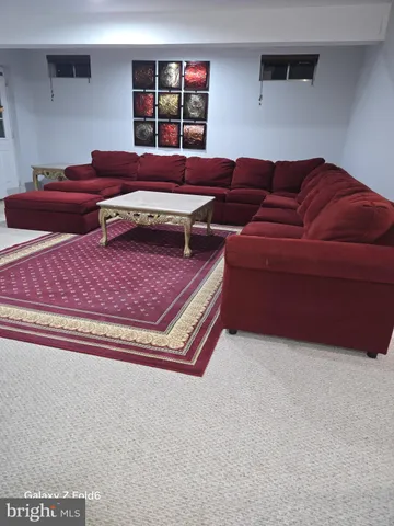 a living room with furniture and a rug