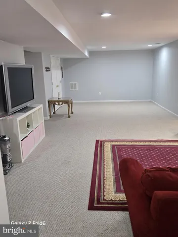 a living room with a couch and a flat screen tv