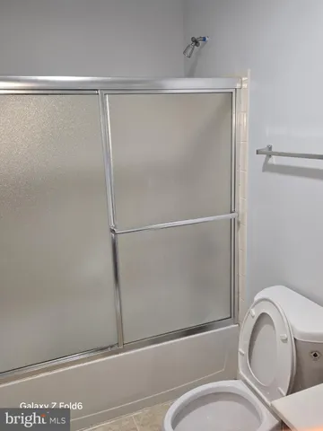 a bathroom with a shower and a toilet