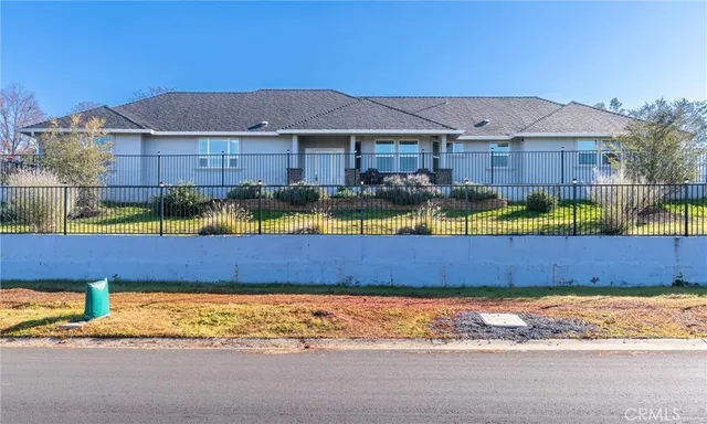 a view of an house with backyard space and balcony