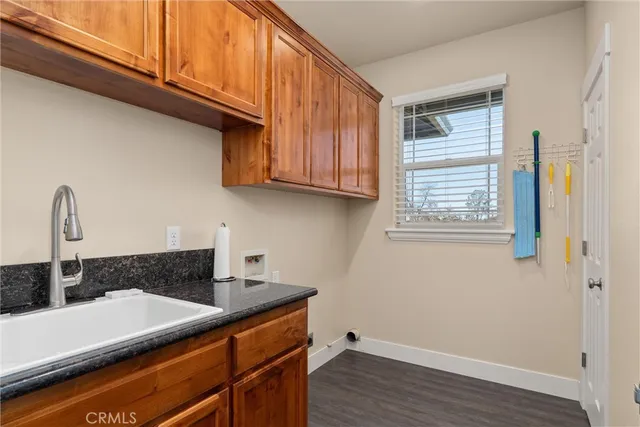 a view of a house with a small yard and wooden fence