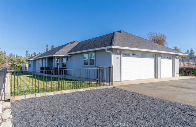 a view of a house with backyard and sitting area