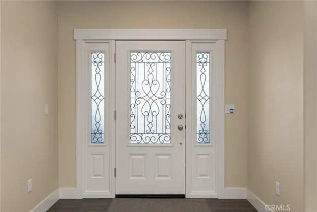 a living room with furniture a ceiling fan a lamp and a window