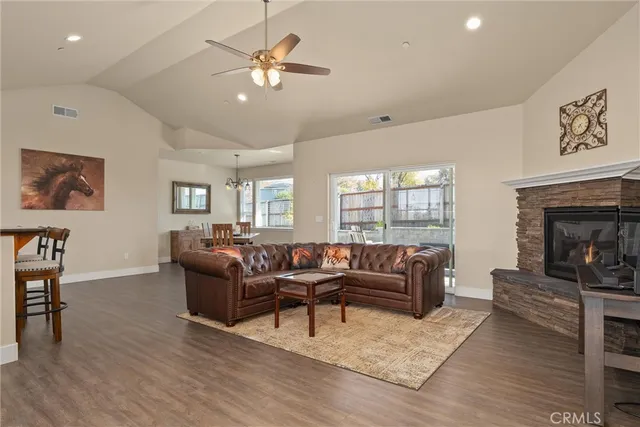 a living room with furniture a window and a fireplace