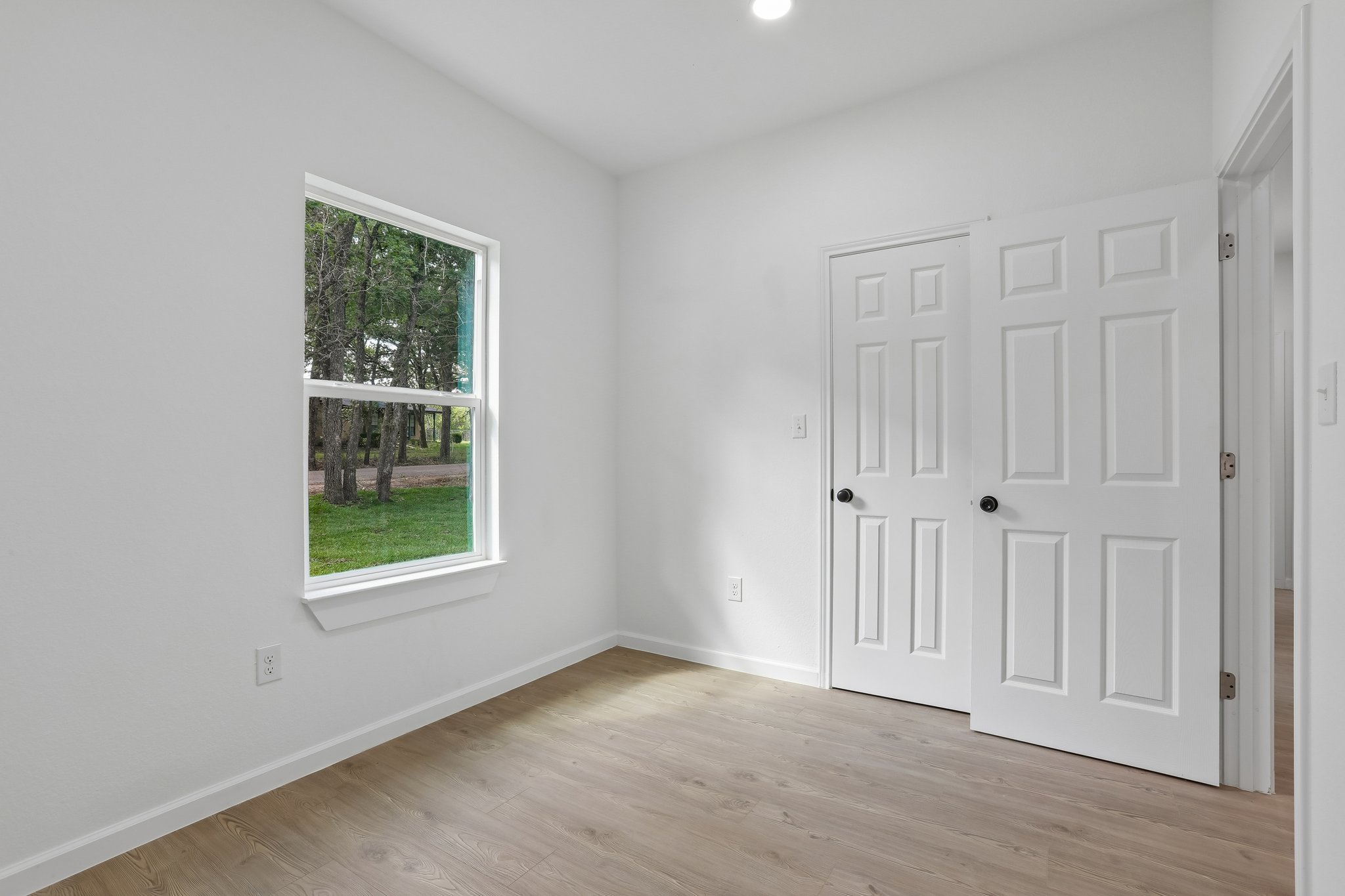 210 Flint Ridge Street Bastrop, TX 78602 - Photo 20 of 40 an empty room with wooden floor and windows