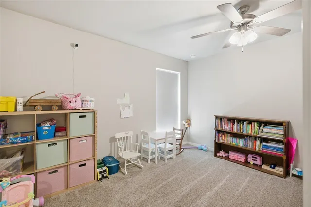 a bedroom with furniture and a book shelf