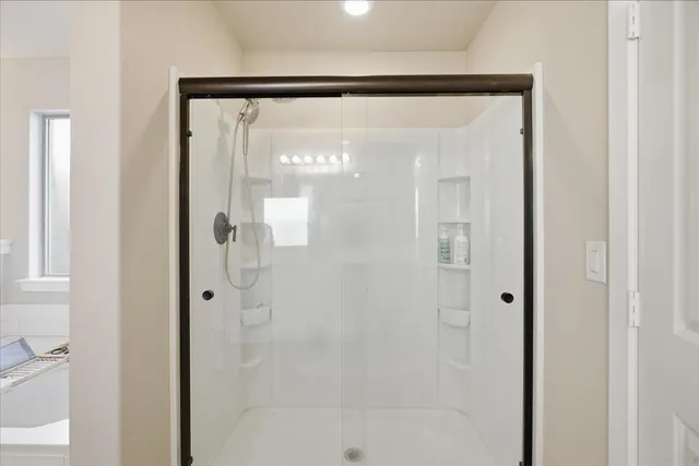 a bathroom with a glass shower door