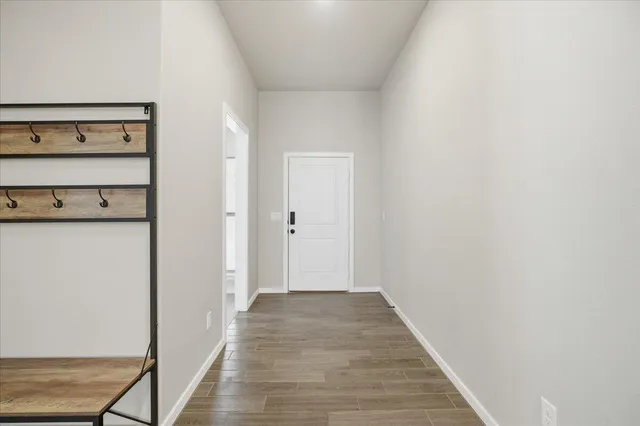 a view of a hallway with wooden floor