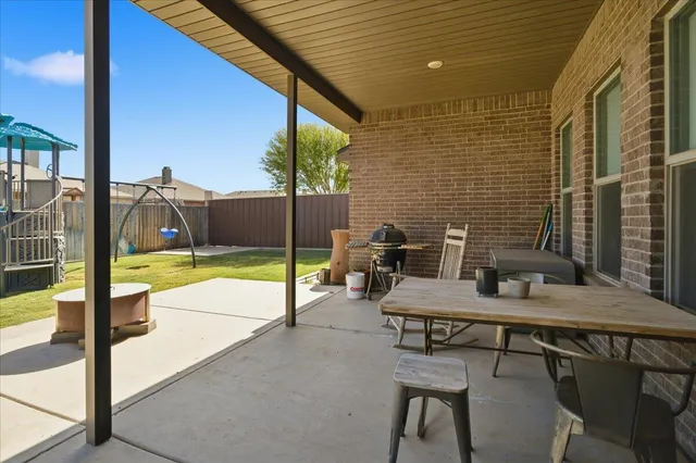 a view of backyard with swimming pool and outdoor seating
