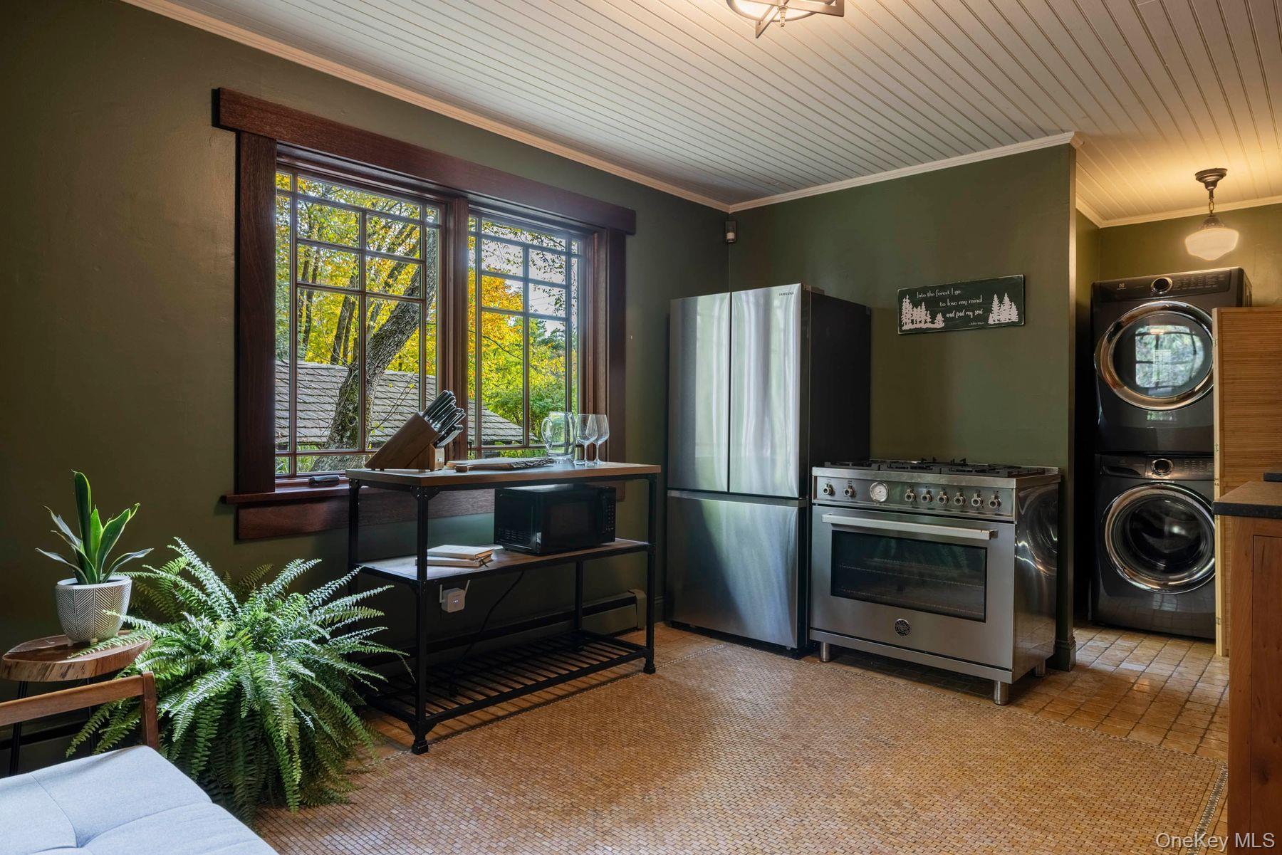 64 Lower Byrdcliffe Road Woodstock, NY 12498 - Photo 14 of 36 a view of kitchen with stainless steel appliances kitchen island granite countertop a refrigerator and a blue plant