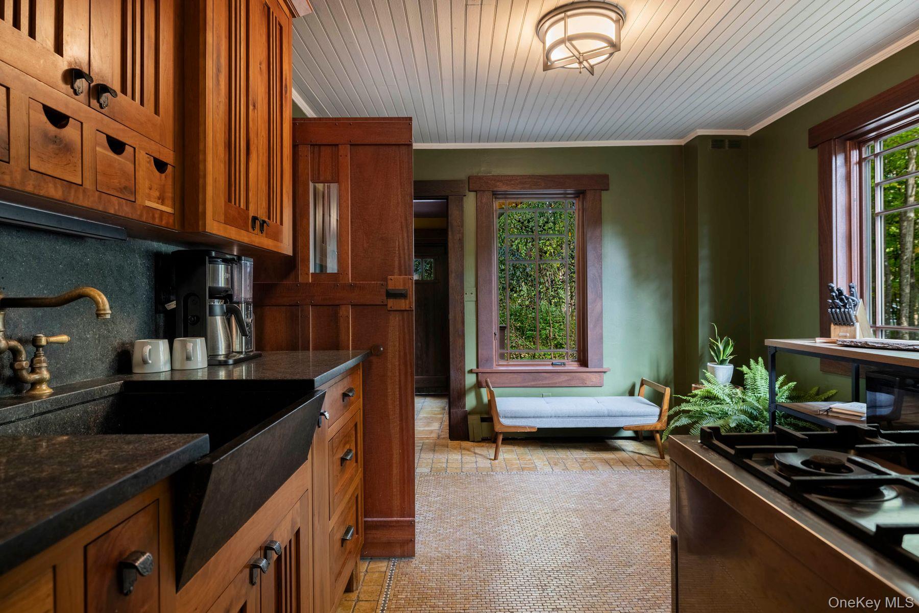 64 Lower Byrdcliffe Road Woodstock, NY 12498 - Photo 15 of 36 a kitchen with granite countertop a stove a sink and dishwasher wooden cabinets with granite countertops