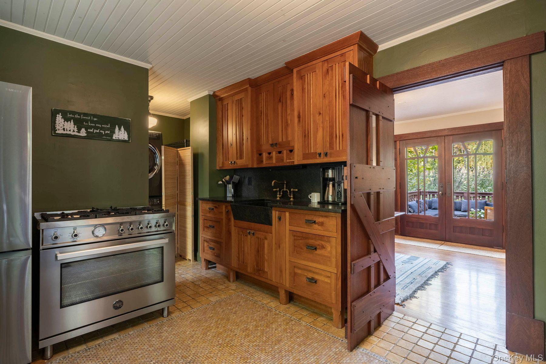 64 Lower Byrdcliffe Road Woodstock, NY 12498 - Photo 16 of 36 a kitchen with stainless steel appliances granite countertop a stove and a refrigerator