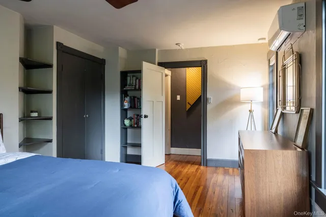 a bedroom with a bed and a mirror