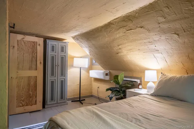 a view of a bedroom with furniture and a window