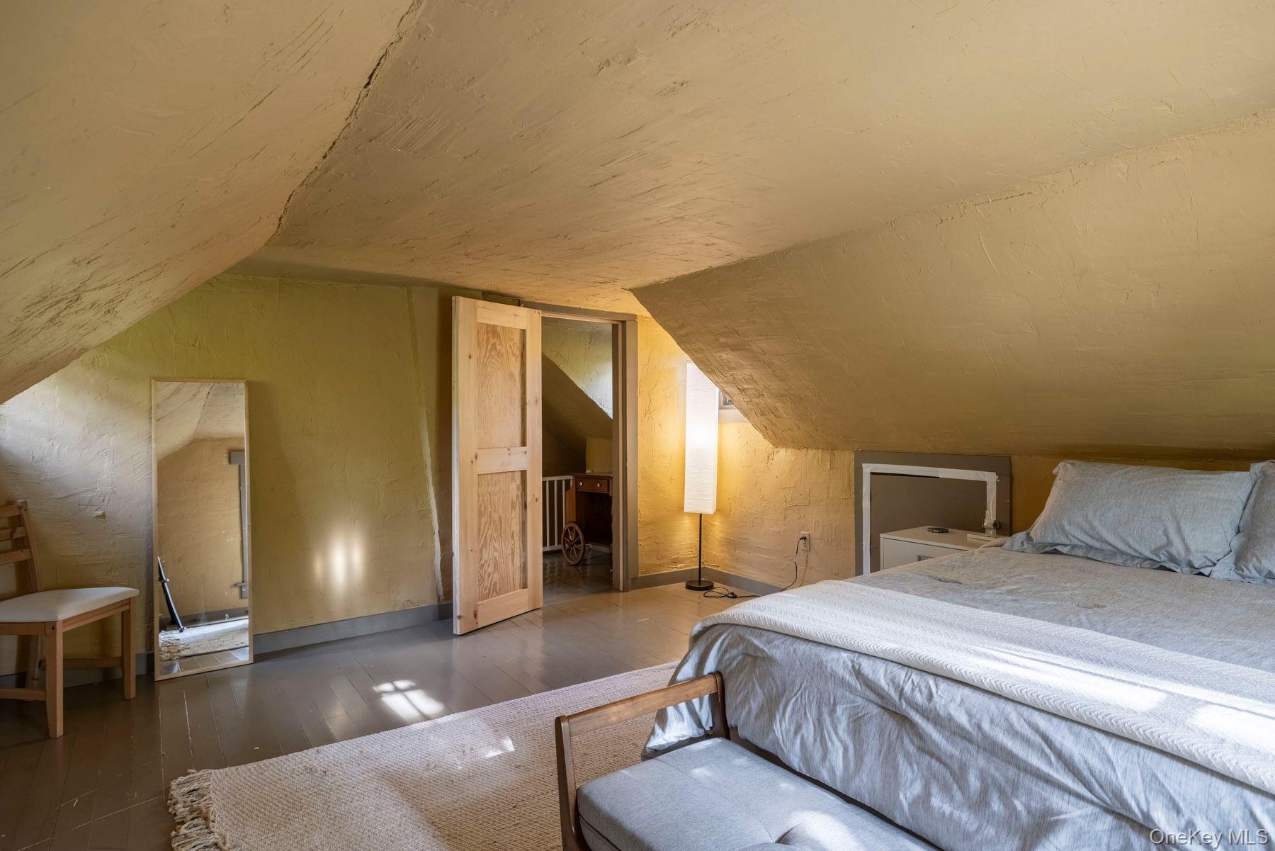 64 Lower Byrdcliffe Road Woodstock, NY 12498 - Photo 28 of 36 a spacious bedroom with a bed and wooden floor