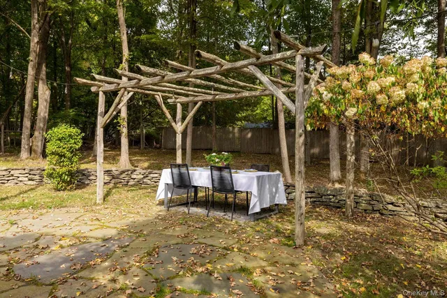 a view of a patio with table and chairs and potted plants