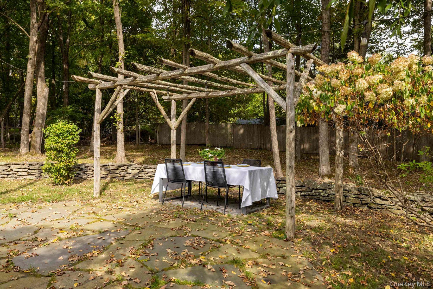 64 Lower Byrdcliffe Road Woodstock, NY 12498 - Photo 29 of 36 a view of a patio with table and chairs and potted plants