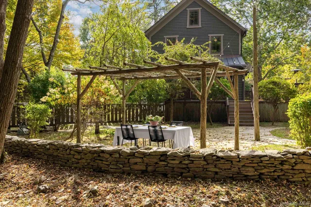 a view of a chairs and table in the backyard
