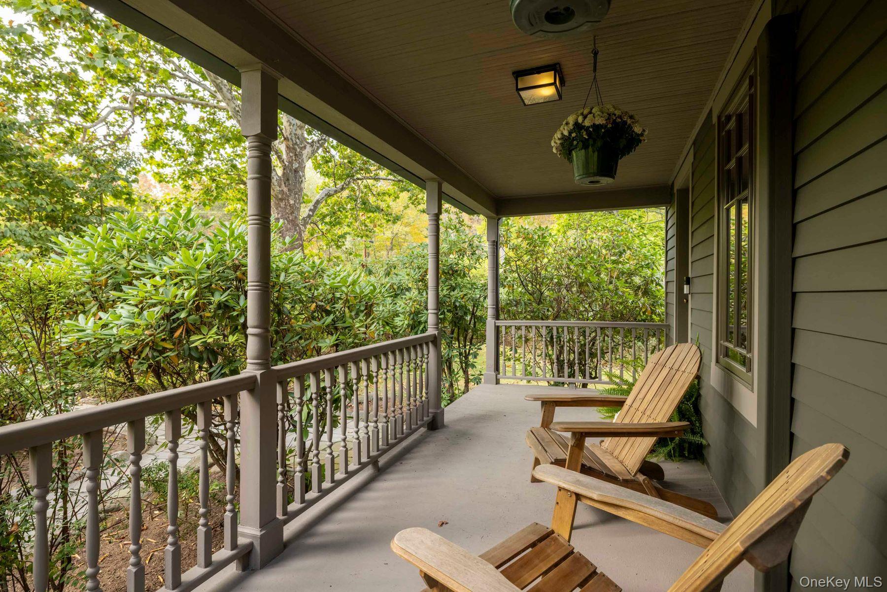 64 Lower Byrdcliffe Road Woodstock, NY 12498 - Photo 6 of 36 a view of a balcony with chairs and floor to ceiling window