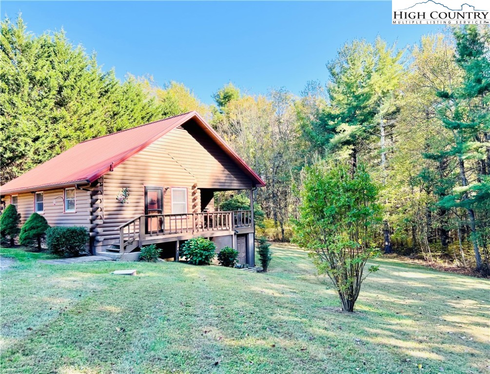 840 Golf Course Road Sparta, NC 28675 - Photo 19 of 35 a view of a house with backyard and a tree