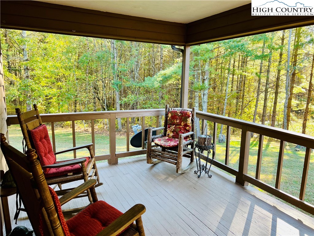 840 Golf Course Road Sparta, NC 28675 - Photo 5 of 35 a living room with furniture and a floor to ceiling window