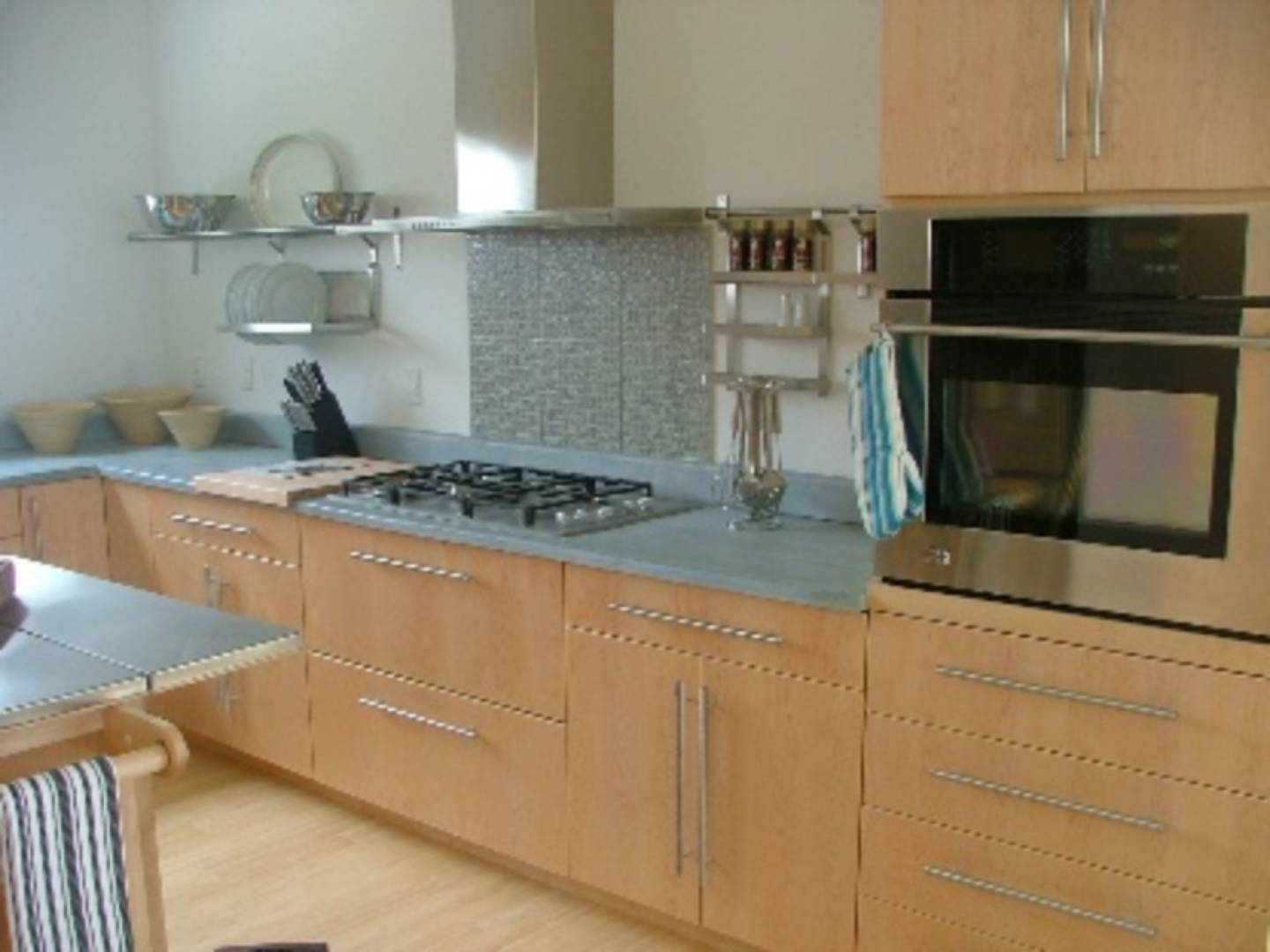 9 Cliff Drive Sag Harbor, NY 11963 - Photo 2 of 7 a kitchen with granite countertop white cabinets and stainless steel appliances